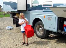 Summer loading her bag on motorhome